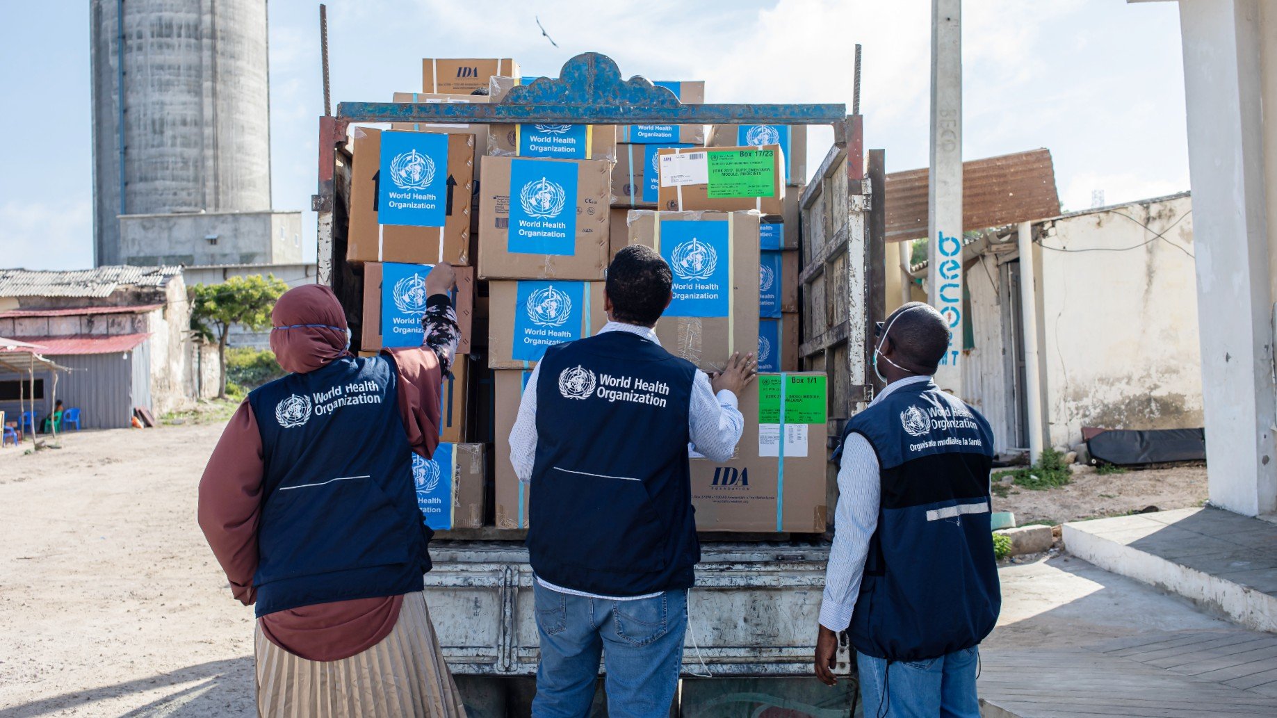 WHO staff inspects a truck with medical and hygiene supplies.