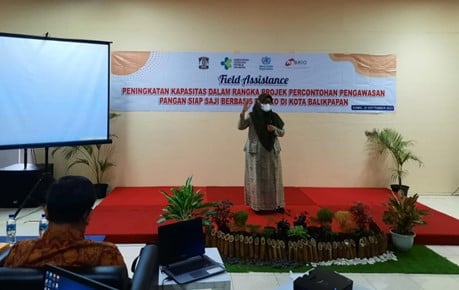 A woman, an official of Ministry of Health, spoke in front of a meeting room.