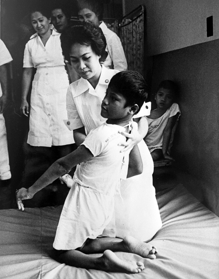 A student nurse attends to a cerebral polio patient. She is part of UP Manila’s physiotherapy course.